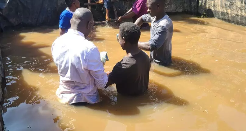 Community members gather for a baptism during the Eburru mission